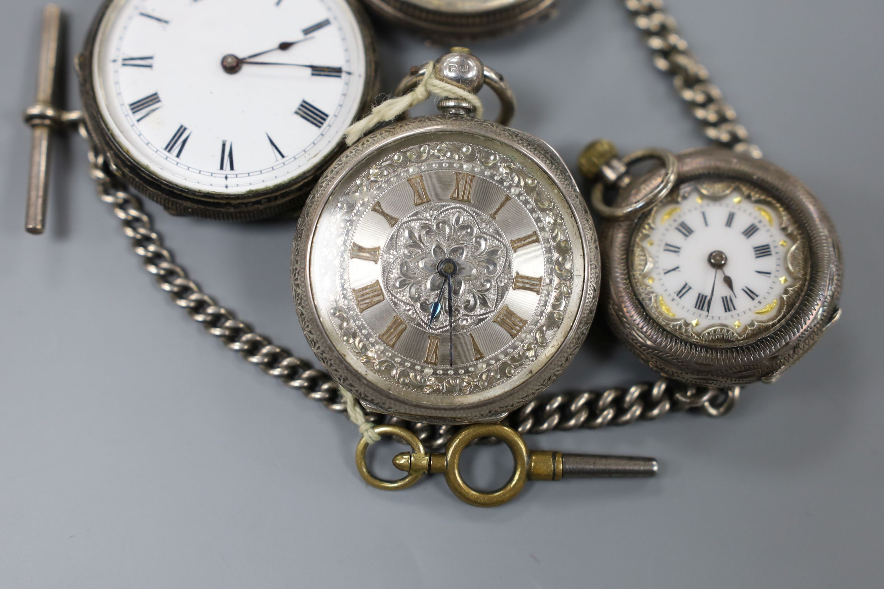 Four assorted late 19th century silver or white metal fob watches including two with case.